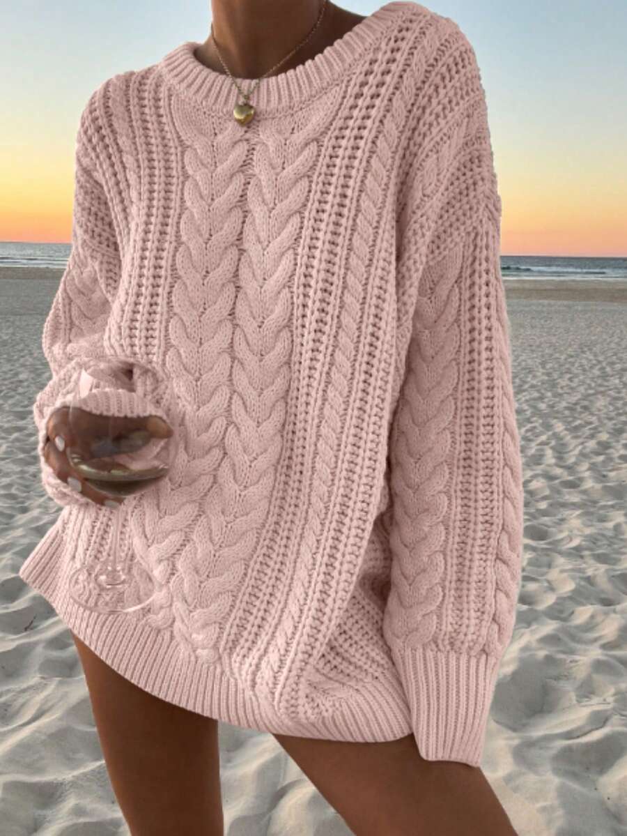 Aria cable-knit sweater worn with jeans