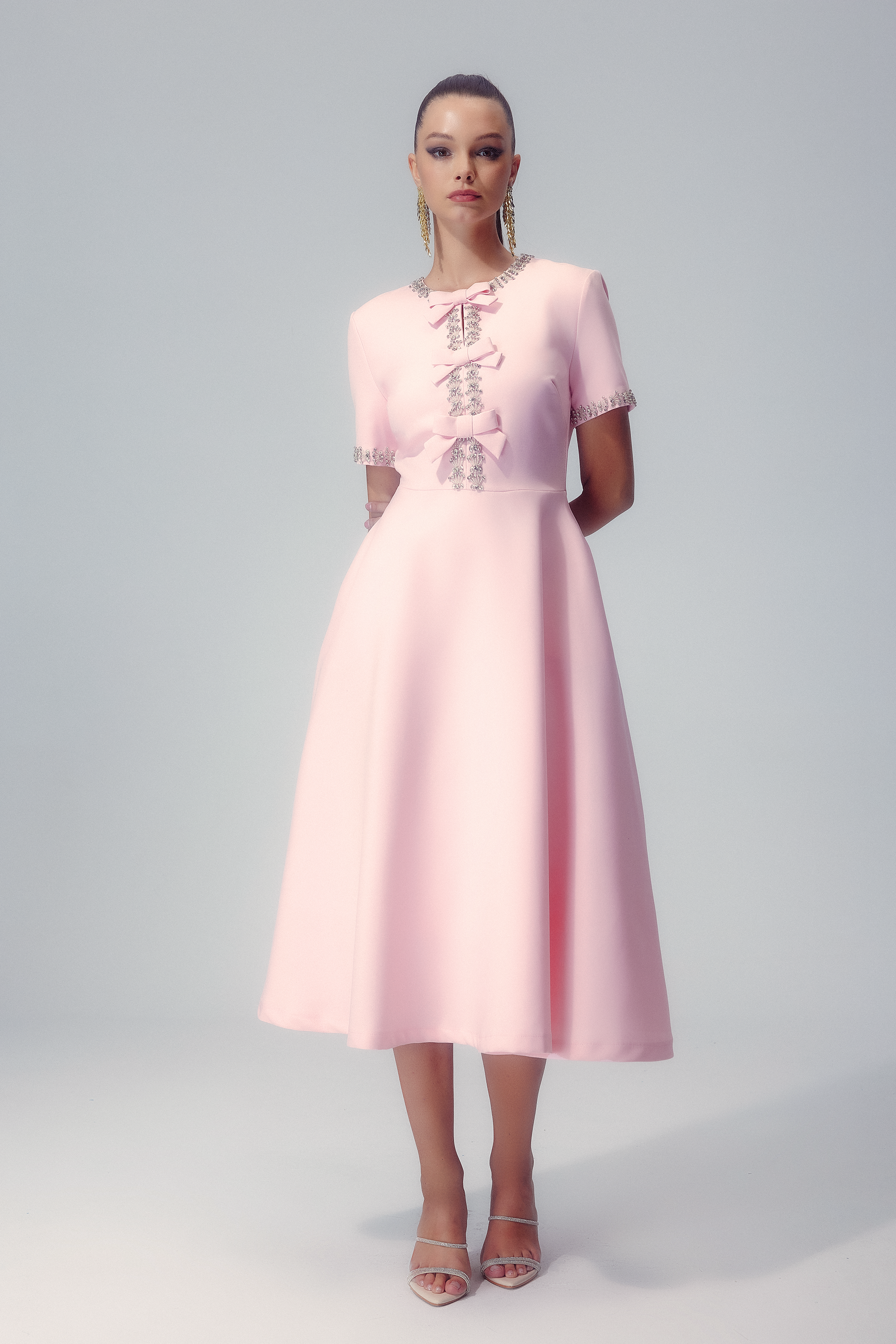Front view of the Elise crystal bow midi dress