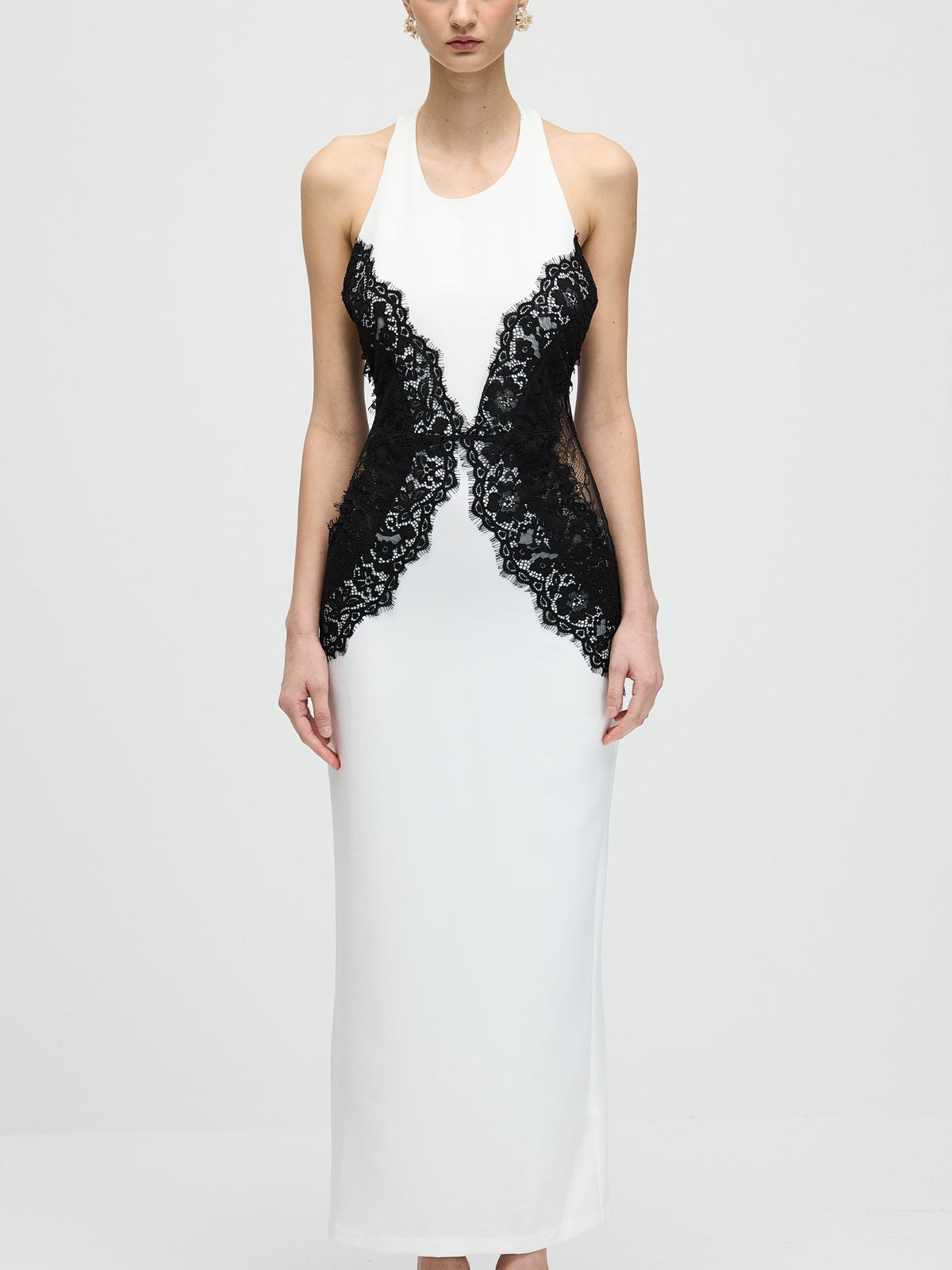White midi dress with black lace detail on a neutral backdroplb1