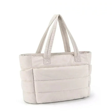 Cream padded tote bag on a white surface